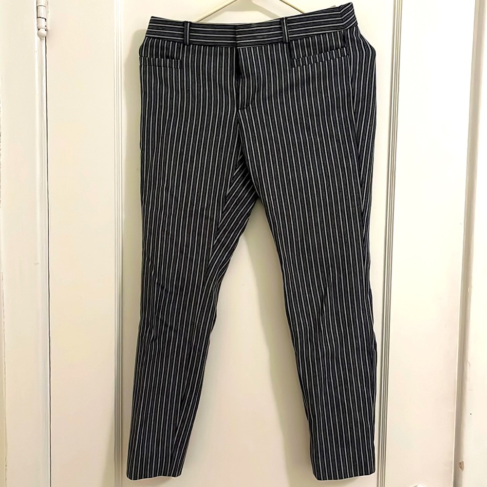 Navy blue and white striped, cropped trousers.